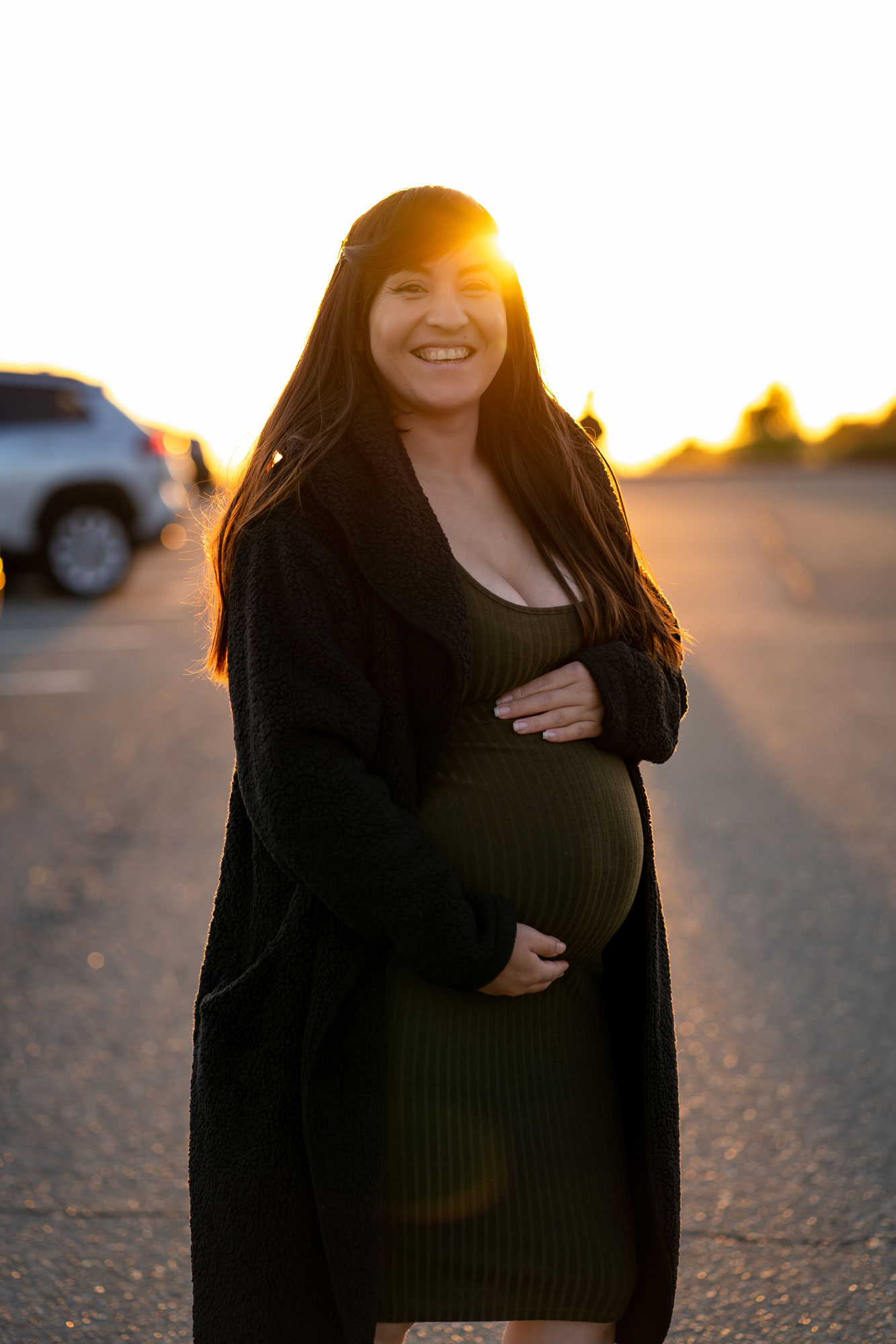 Karla standing outdoors at sunset during her pregnancy, before Gael was born.