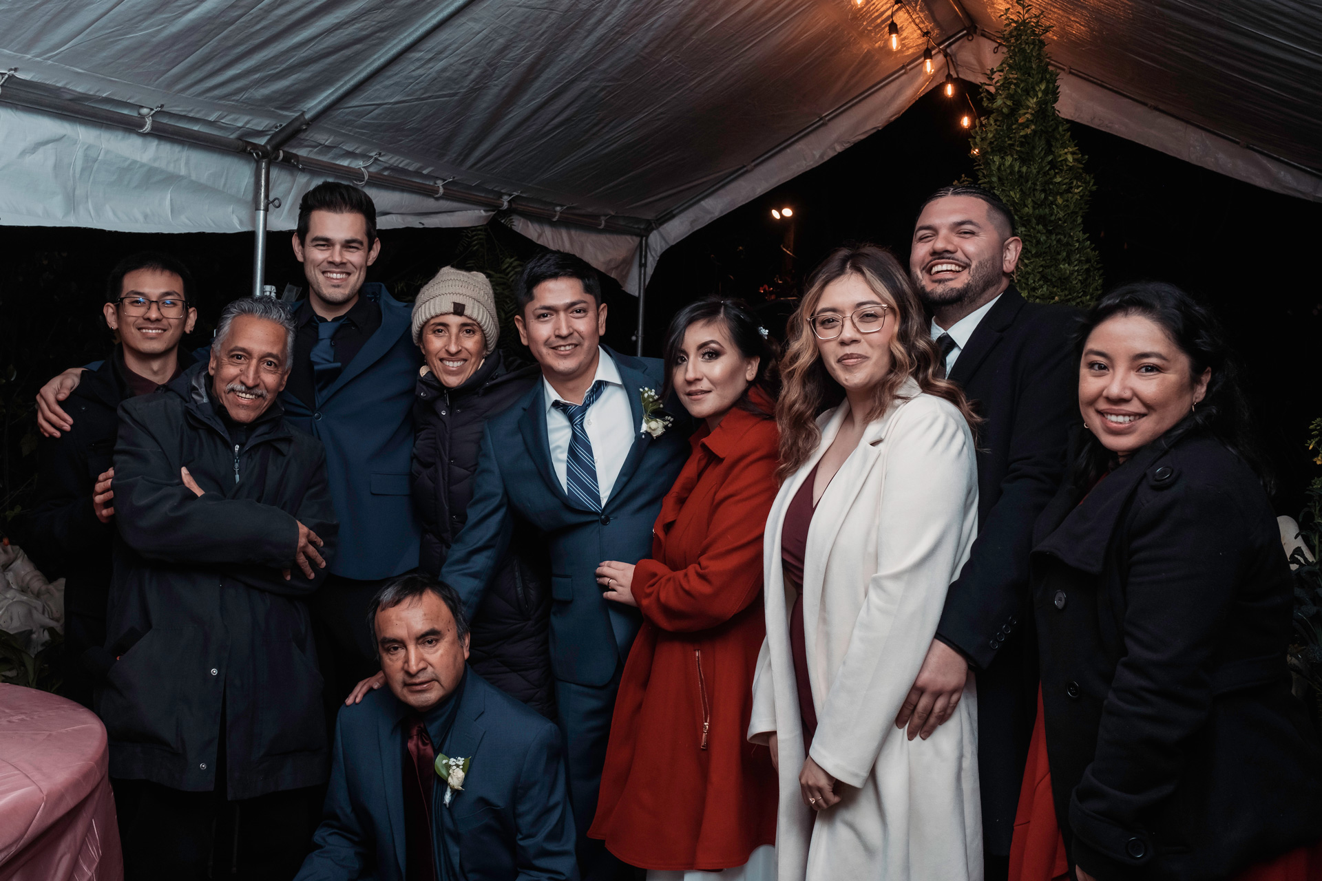 Karla and Birhon celebrating their wedding with a group of family and friends.