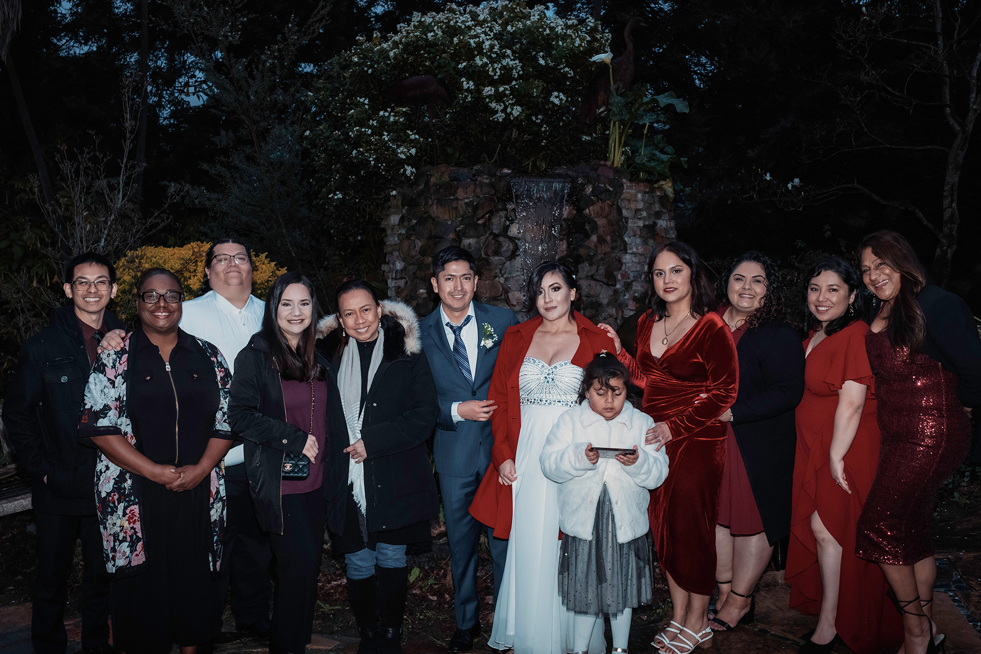 Karla and Birhon standing with their loved ones for a wedding group photograph.